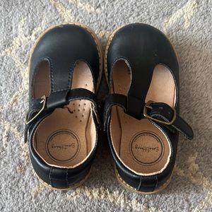 Sweet Honey Black leather t strap shoe with rubber sole.